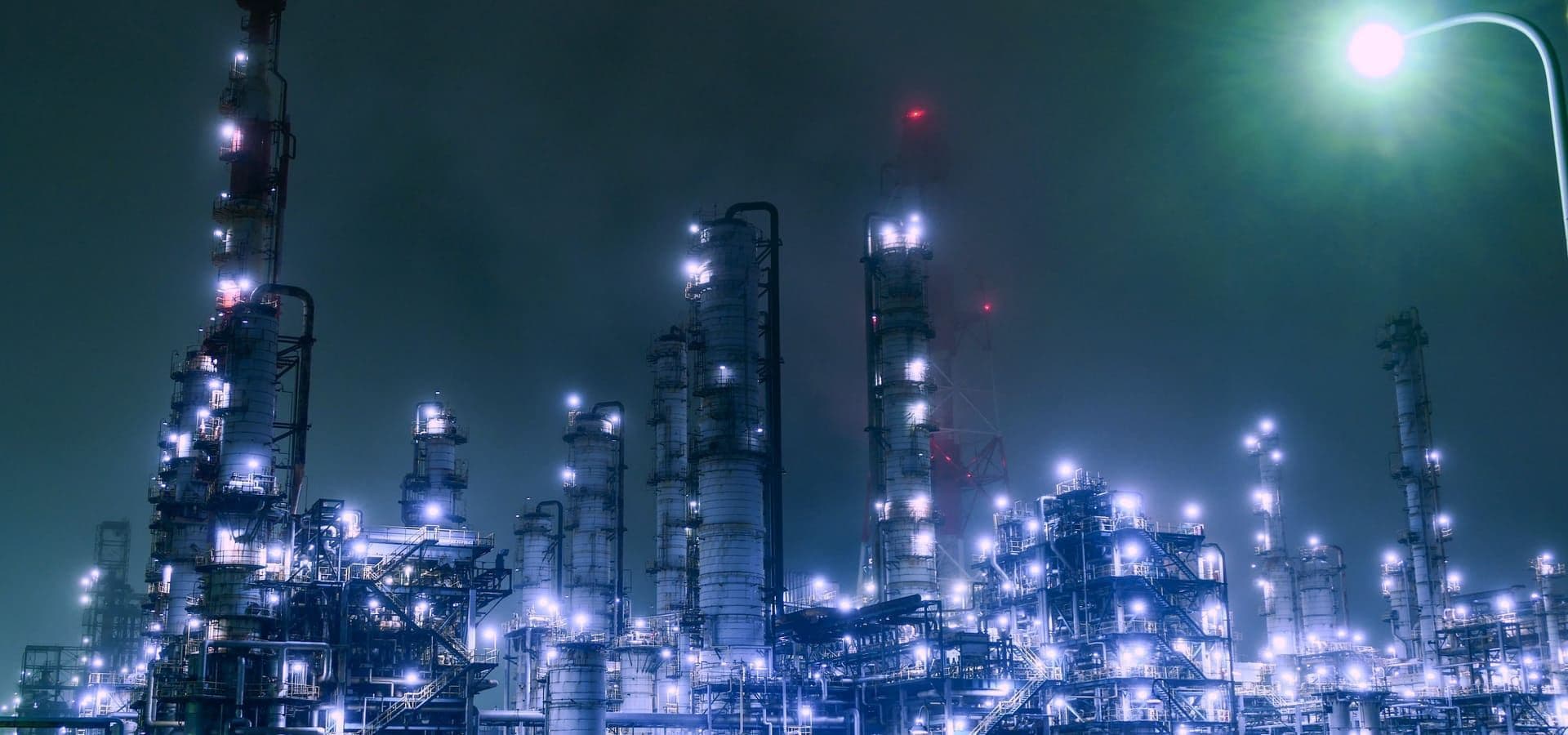 Industrial process plant with pipework and equipment illuminated at night